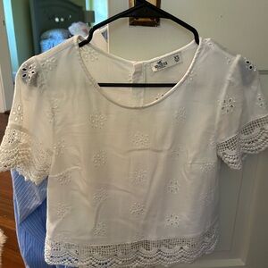 White holistic top with flower detailing